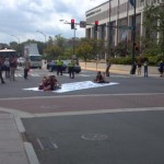 Protesters sit in the streets during the convention.