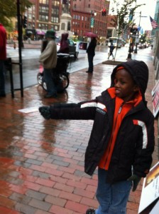 Hebert's adopted 8-year-old son from Ethiopia offers a passerby a tract.