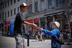 Sippley's son gives Gospel literature to a teenager on the streets of Quebec.