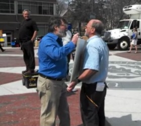 Boster yells at evangelist Don Karns as he holds a sign decrying evolution. 