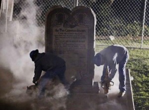 Workers remove the Oklahoma Ten Commandments monument by night.