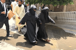 Neha Faqir (R) in Islamic dress on way to court in Lahore, Pakistan. (CSI)
