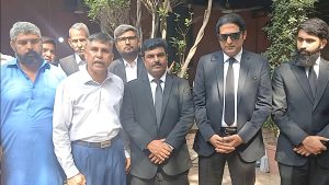 Shahbaz Masih (L), rights activist Safdar Choudhry (in blue pants) and legal team for Maria Shahbaz’s family outside the Lahore High Court on Oct. 1, 2026. (Christian Daily International-Morning Star News)